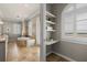 Luxurious bathroom with soaking tub, travertine tile, and built-in shelving at 610 S Rome Ave # 602, Tampa, FL 33606