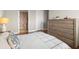 Bedroom leading to bathroom with patterned wallpaper, hardwood floors and neutral color tones at 610 S Rome Ave # 602, Tampa, FL 33606