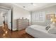 Comfortable bedroom with hardwood floors, neutral tones, and large dresser at 610 S Rome Ave # 602, Tampa, FL 33606