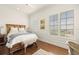 Bright bedroom with warm hardwood floors and natural light with views of outside at 610 S Rome Ave # 602, Tampa, FL 33606