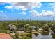Beautiful skyline view from the top of the building surrounded by lush greenery and a tranquil pond in the foreground at 610 S Rome Ave # 602, Tampa, FL 33606