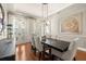 Stylish dining room with modern lighting, an adjacent window, and hardwood floors at 610 S Rome Ave # 602, Tampa, FL 33606