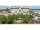 Beautiful condo building surrounded by lush greenery, with palm trees and other landscaping features at 610 S Rome Ave # 602, Tampa, FL 33606