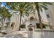 Upscale building exterior featuring a gated entry, well-manicured greenery, and an address plaque at 610 S Rome Ave # 602, Tampa, FL 33606