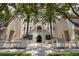 Elegant condominium exterior with a gated entrance and lush palm trees along the entry stairs at 610 S Rome Ave # 602, Tampa, FL 33606
