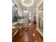 Elegant foyer with a staircase, hardwood floors, and a stylish console table with decorative art at 610 S Rome Ave # 602, Tampa, FL 33606