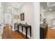 Inviting hallway with hardwood floors, elegant furnishings, and views into other rooms at 610 S Rome Ave # 602, Tampa, FL 33606