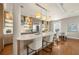 Open-concept kitchen with island seating and stainless steel appliances at 610 S Rome Ave # 602, Tampa, FL 33606