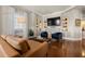 Elegant living room with hardwood floors, built-in bookshelves, fireplace, and comfortable seating at 610 S Rome Ave # 602, Tampa, FL 33606