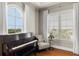 Cozy living room area with piano, chair, and ample natural light at 610 S Rome Ave # 602, Tampa, FL 33606