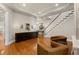 Bright living space with hardwood floors, built-in bookshelves, and staircase, blending comfort and style at 610 S Rome Ave # 602, Tampa, FL 33606