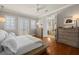 Bright main bedroom featuring hardwood floors, access to the balcony, and a view into the bathroom at 610 S Rome Ave # 602, Tampa, FL 33606