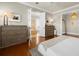 Sunlit main bedroom with hardwood floors and a doorway to the bathroom at 610 S Rome Ave # 602, Tampa, FL 33606