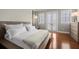 Bright and spacious main bedroom with hardwood floors and a balcony view at 610 S Rome Ave # 602, Tampa, FL 33606