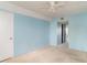 A carpeted bedroom with ceiling fan, closet, and light blue paint, ready for personalization and comfort at 635 30Th W Ave # F309, Bradenton, FL 34205