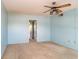 A bright bedroom with carpet and vintage ceiling fan and view to another room at 635 30Th W Ave # F309, Bradenton, FL 34205