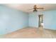 Bedroom featuring a ceiling fan and carpet and a view to another room at 635 30Th W Ave # F309, Bradenton, FL 34205