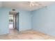 Bright bedroom with carpet, ceiling fan, blue walls, with view to the enclosed balcony at 635 30Th W Ave # F309, Bradenton, FL 34205