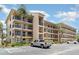 Exterior of a modern condo building featuring multiple stories, parking, and balconies for each unit at 635 30Th W Ave # F309, Bradenton, FL 34205