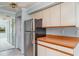 Traditional kitchen featuring wood-trimmed cabinets and stainless steel refrigerator and a view to the lanai at 635 30Th W Ave # F309, Bradenton, FL 34205
