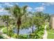 Scenic view of a lake with palm trees and lush landscaping from a building's upper level at 635 30Th W Ave # F309, Bradenton, FL 34205
