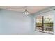 A sunny lanai featuring a blue light fixture and a window with blinds and a view at 635 30Th W Ave # F309, Bradenton, FL 34205