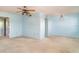 A bright living room with carpet and vintage ceiling fan and view to another room at 635 30Th W Ave # F309, Bradenton, FL 34205