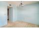 A bright living room featuring a blue light fixture and a view to the kitchen at 635 30Th W Ave # F309, Bradenton, FL 34205