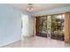 Living room featuring light blue walls, fan, sliding glass doors to a screened lanai, and neutral flooring at 635 30Th W Ave # F309, Bradenton, FL 34205