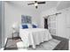 Bright bedroom boasts a ceiling fan, light gray walls, stylish rug, and en-suite bathroom and walk-in closet at 777 N Ashley Dr # 2312, Tampa, FL 33602