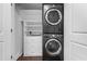 Convenient laundry closet has a stacked washer and dryer plus storage shelves at 777 N Ashley Dr # 2312, Tampa, FL 33602