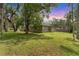 Expansive backyard with lush lawn, mature trees, and plenty of room for outdoor activities at 7809 E 114Th Ave, Temple Terrace, FL 33617