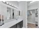 Modern bathroom boasts a spacious walk-in closet, dual mirrors with vanity lighting, and dark wood cabinets at 7809 E 114Th Ave, Temple Terrace, FL 33617