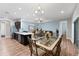 Open concept kitchen and dining room area with decorative table and hardwood floors at 7809 E 114Th Ave, Temple Terrace, FL 33617