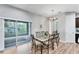 Dining room with sliding doors leading to a screened in porch with lots of natural light at 7809 E 114Th Ave, Temple Terrace, FL 33617