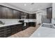 Well-equipped kitchen with dark cabinets, stainless steel appliances, and marble countertops at 7809 E 114Th Ave, Temple Terrace, FL 33617