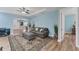 Bright and cozy living room featuring an arched doorway, wood floors, and comfortable seating at 7809 E 114Th Ave, Temple Terrace, FL 33617