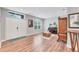Comfortable living room featuring wood floors, a piano, and bright window at 7809 E 114Th Ave, Temple Terrace, FL 33617