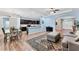 Open-concept living space with modern lighting, hardwood floors, and kitchen with island at 7809 E 114Th Ave, Temple Terrace, FL 33617