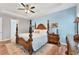 Comfortable main bedroom featuring a wooden bed frame and hardwood floors at 7809 E 114Th Ave, Temple Terrace, FL 33617