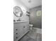 Modern bathroom with hexagon tile wall, sleek vanity, and a stylish round mirror at 851 3Rd Ave N, St Petersburg, FL 33701