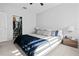 Bedroom with white bed frame, blue comforter, ceiling fan, and walk in closet with organized storage at 851 3Rd Ave N, St Petersburg, FL 33701
