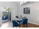 Modern dining area featuring a glass table with blue chairs, and sliding doors leading to an outdoor area at 851 3Rd Ave N, St Petersburg, FL 33701