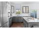 Chic kitchen boasting stainless steel appliances, white subway tiles, and gray cabinetry at 851 3Rd Ave N, St Petersburg, FL 33701