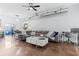 Open living room featuring polished floors, modern decor, a gray leather couch, and a large sliding glass door at 851 3Rd Ave N, St Petersburg, FL 33701