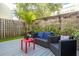 Back patio with outdoor furniture, grey deck, privacy fence and lush plants at 851 3Rd Ave N, St Petersburg, FL 33701