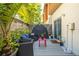 Back patio with outdoor furniture, grey deck, privacy fence and lush plants at 851 3Rd Ave N, St Petersburg, FL 33701