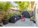 Back patio with outdoor furniture, grey deck, privacy fence and lush plants at 851 3Rd Ave N, St Petersburg, FL 33701