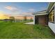 Lawn with an outdoor seating area with a serene water view in the backyard at 8612 Ivy Stark Blvd, Wesley Chapel, FL 33545