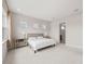 Cozy bedroom features plush carpet, neutral walls and connects to a light-filled bathroom at 8612 Ivy Stark Blvd, Wesley Chapel, FL 33545
